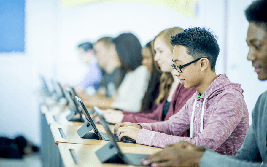 A line of students learning on tablets