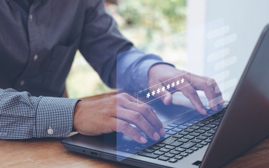 Two hands are visibly typing on a laptop keyboard, with a transparent overlay hovering in the air between.