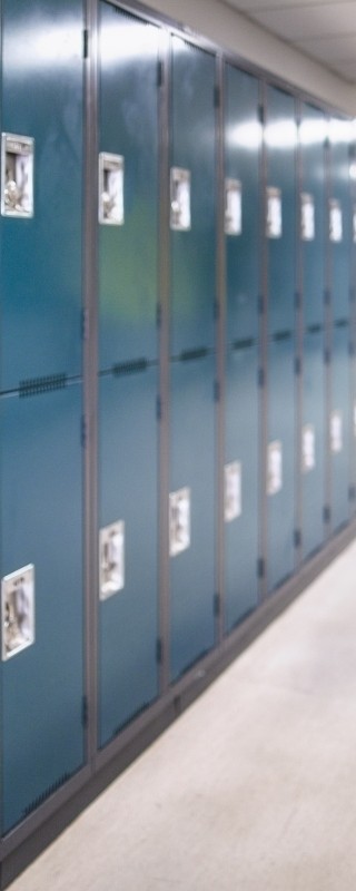 Row of dark blue lockers in a hallway
